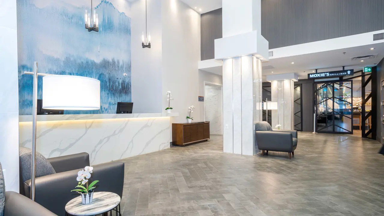 The lobby at Sandman Signature Calgary Downtown, Calgary, featuring modern design with bright lighting and welcoming décor