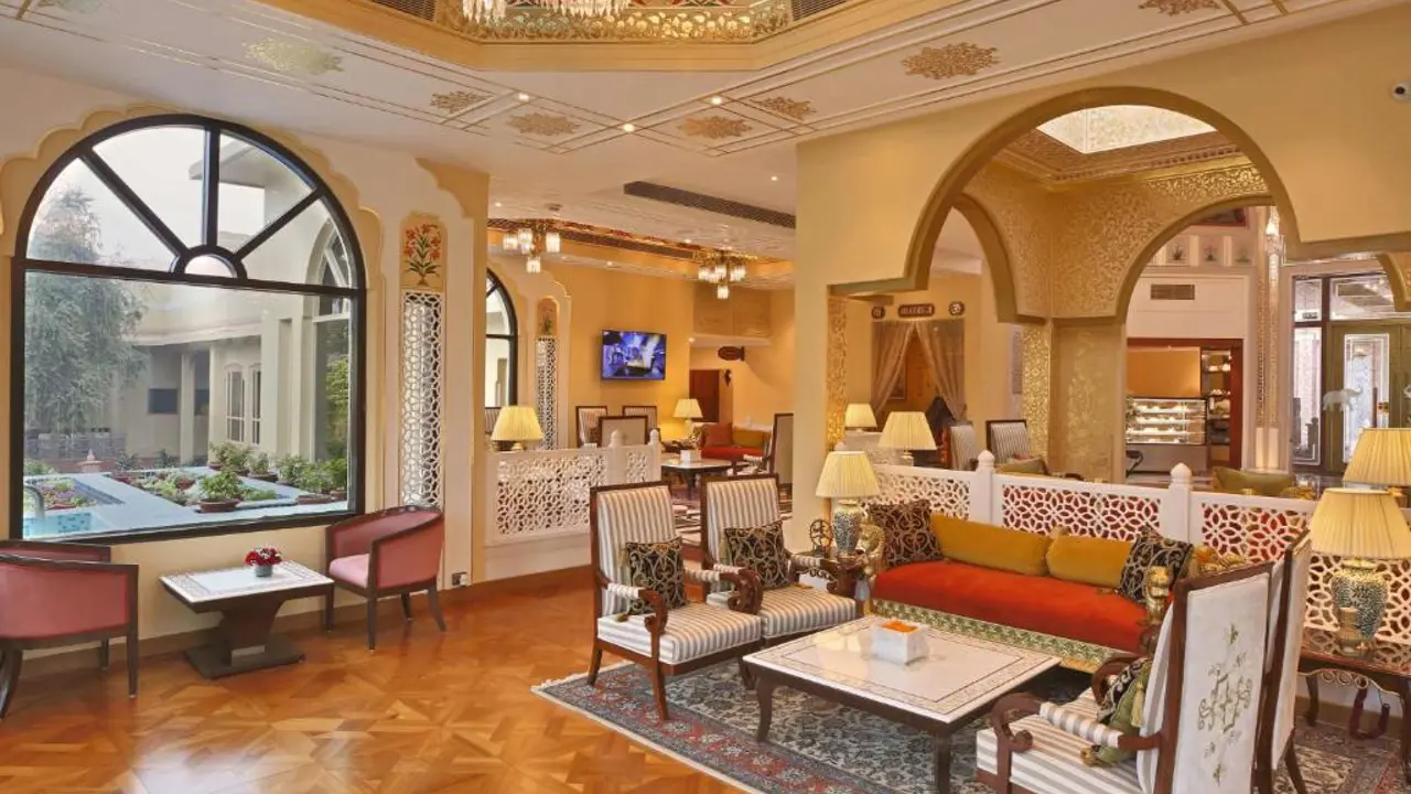 Luxurious lounge at Heritage Village Resort and Spa, Gurugram, featuring ornate arches, patterned ceilings, and elegant seating