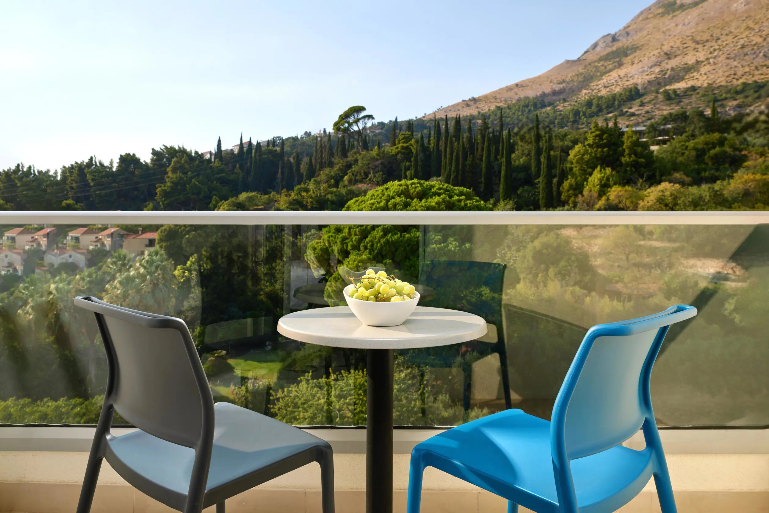 A view from a room balcony at Hotel Horizont, looking out onto the surrounding hills and green landscapes