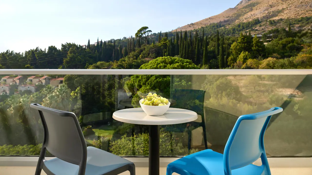 A view from a room balcony at Hotel Horizont, looking out onto the surrounding hills and green landscapes