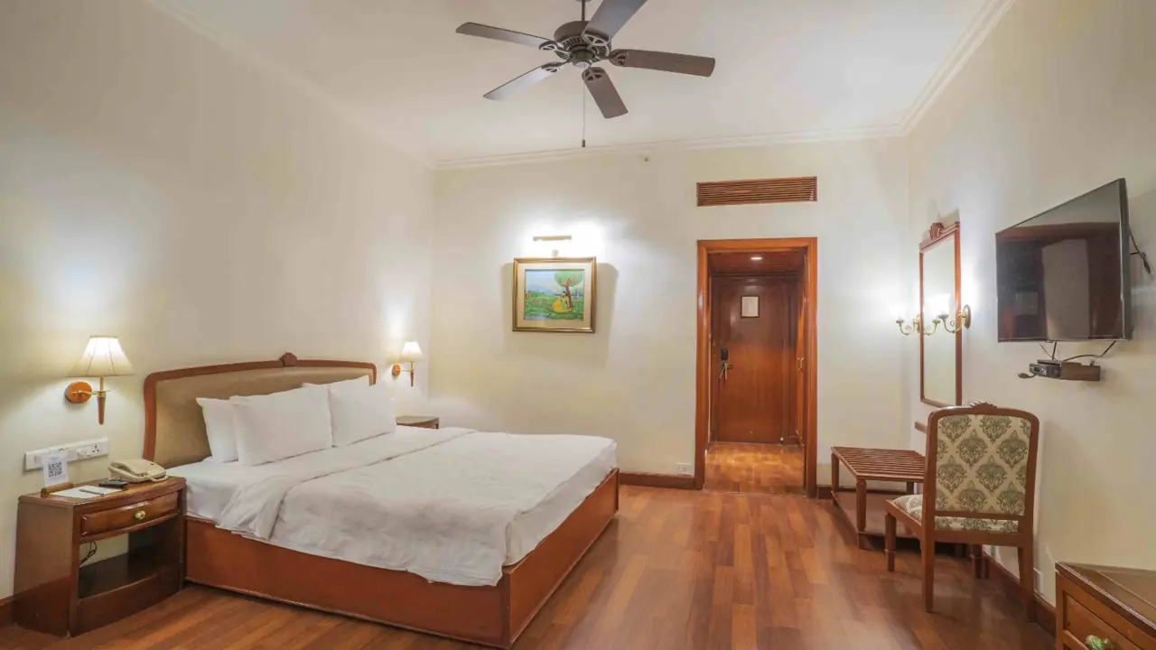 Bright, double guest room at The Taj Gateway Hotel in Madurai, featuring wooden flooring and neutral décor