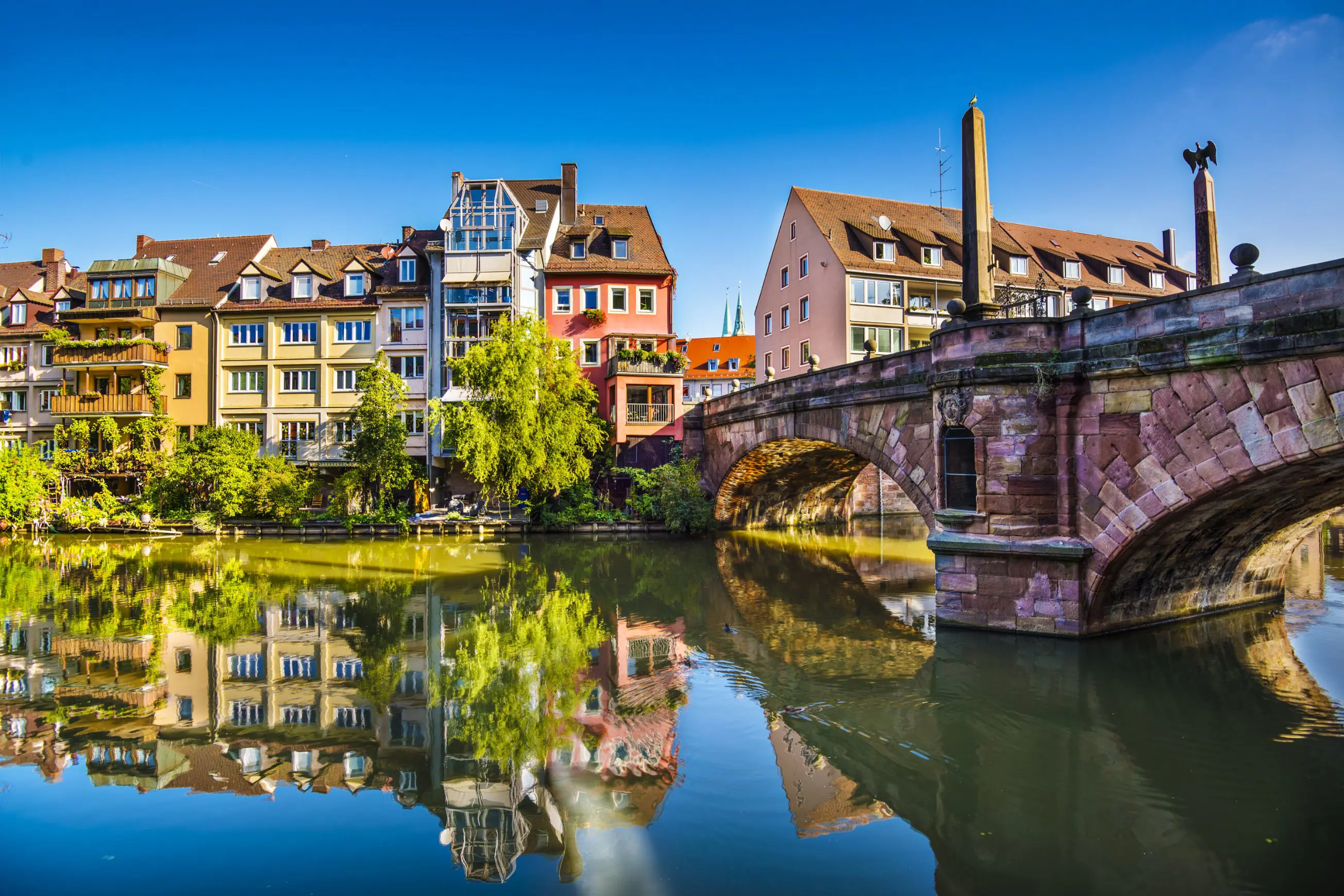 View of Nuremberg river with timber houses on the other side, and a bridge to the right