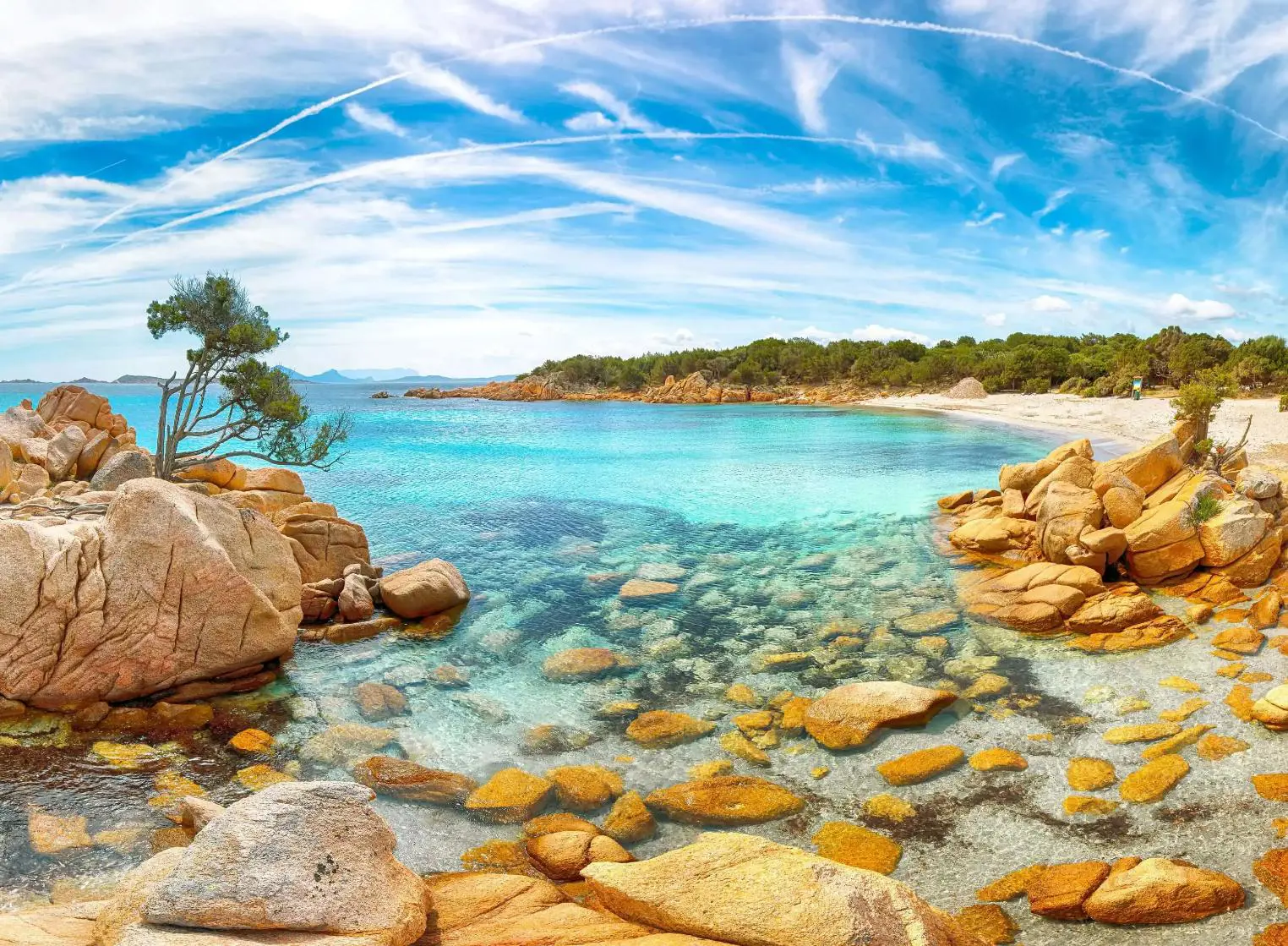 Costa Smeralda seascape in Sardinia, showing the clear blue water and rocks in the forefront