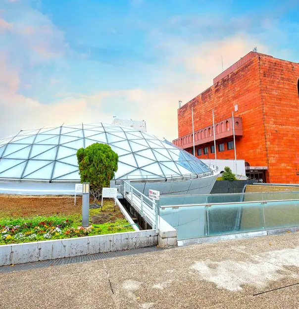 Exterior view of the Nagasaki Atomic Bomb Museum, featuring a modern architectural design and a solemn atmosphere