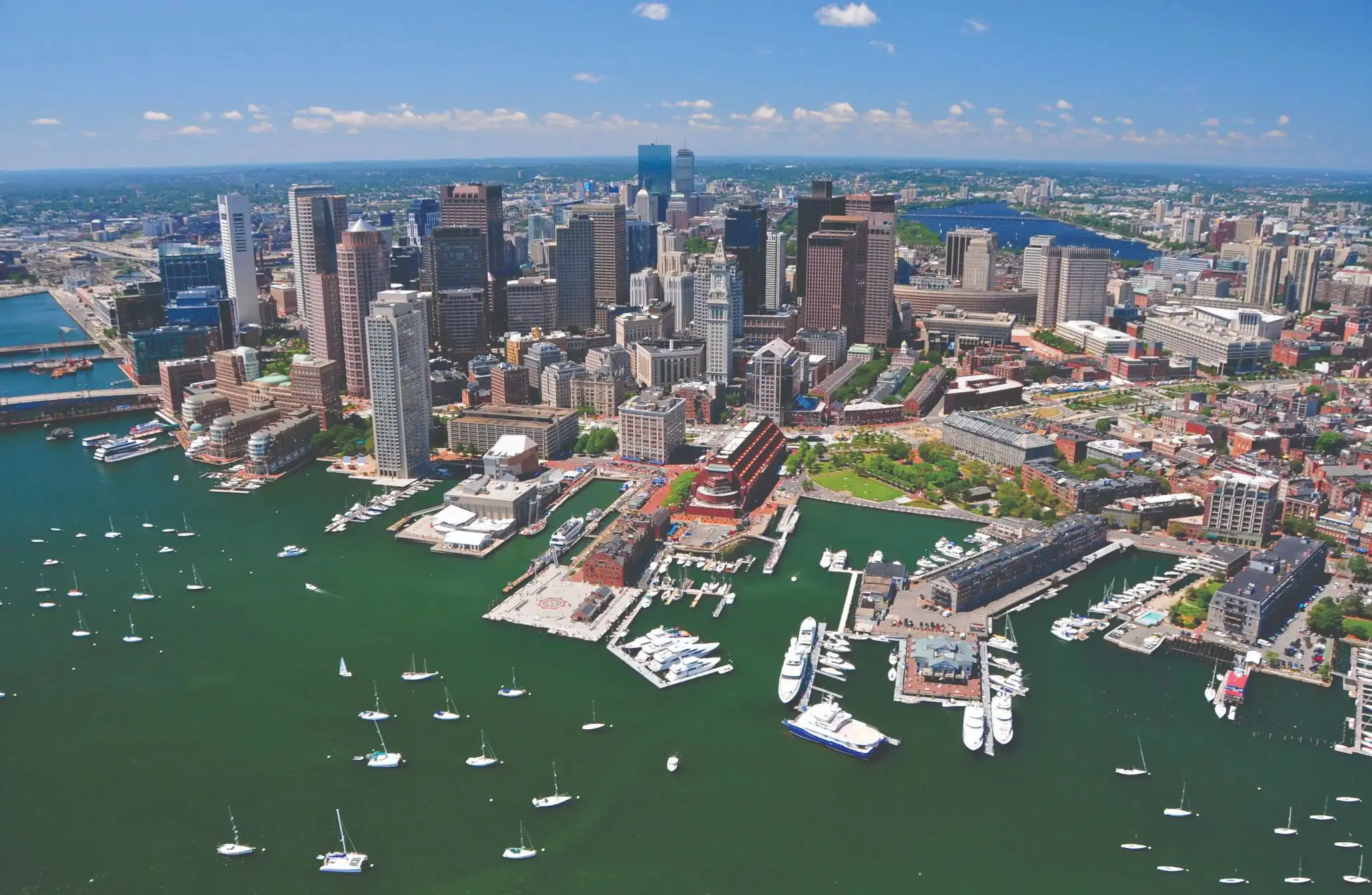 Aerial view of Boston's city skyline and harbour with moored boats