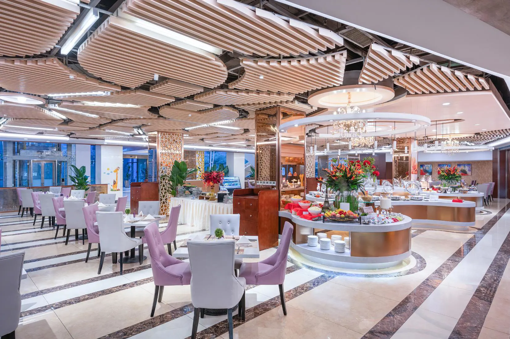 Modern hotel restaurant with elegant lighting, floral centrepieces and neatly set tables at the Mercure Beijing Downtown Hotel in Beijing, China