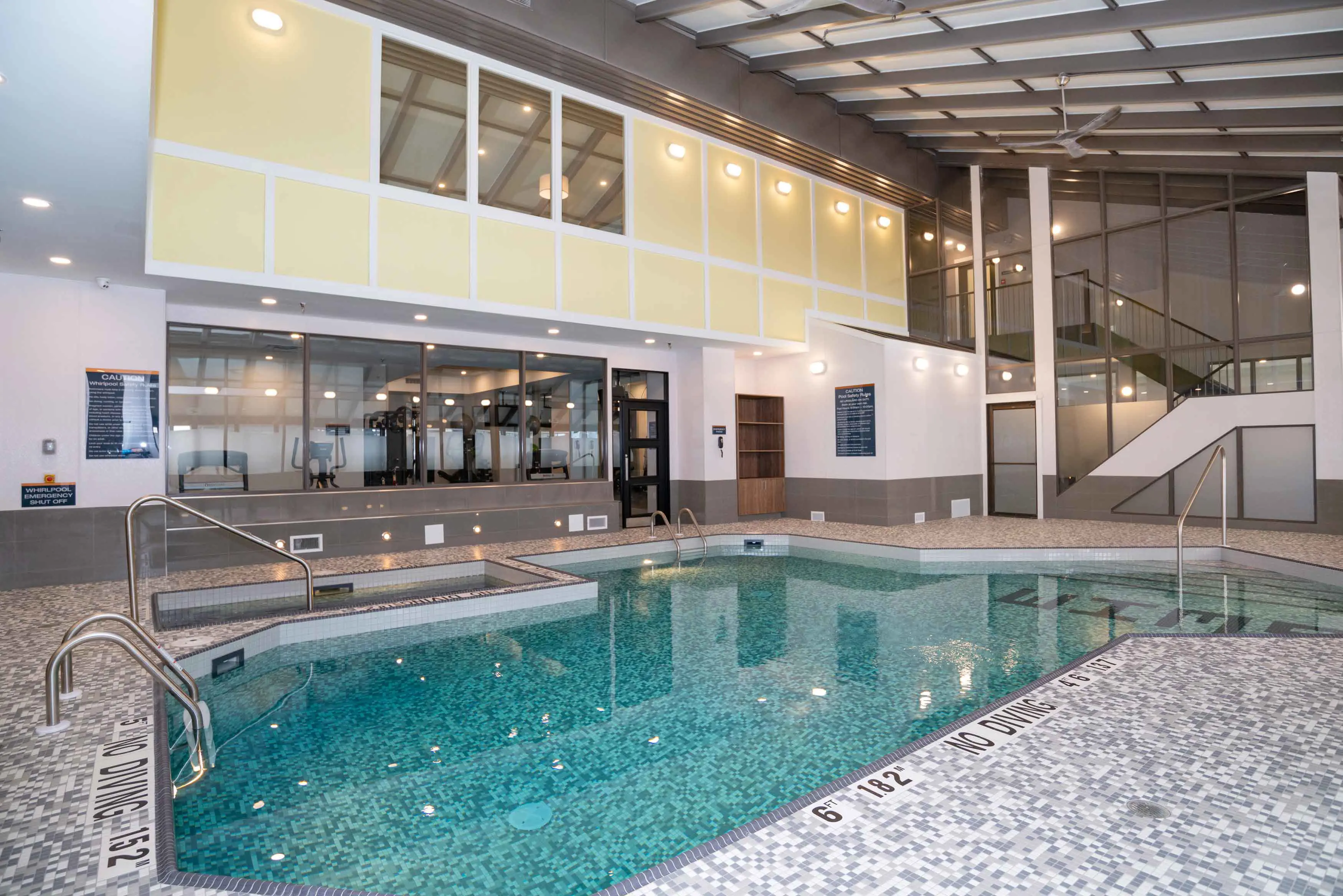 The indoor pool at Sandman Signature Calgary Downtown, Calgary, in a unique architectural space with bright lighting and a modern, clean style