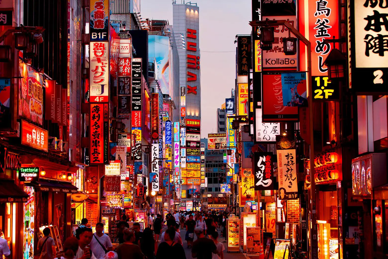 bustling cityscape of Tokyo at dusk, featuring bright lights, high-rise buildings, and busy streets filled with cars and pedestrians