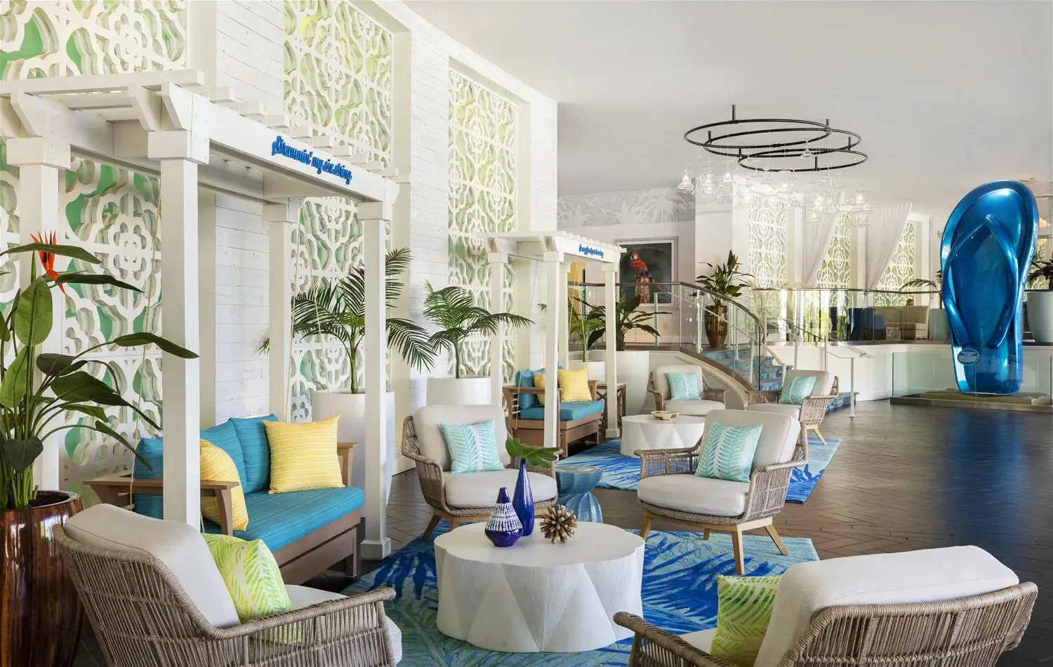 Bright and colourful lobby at the Riviera Resort & Spa, Palm Springs, featuring a vibrant blue and green colour palette, modern white seating with coordinating cushions, and a stylish, contemporary atmosphere
