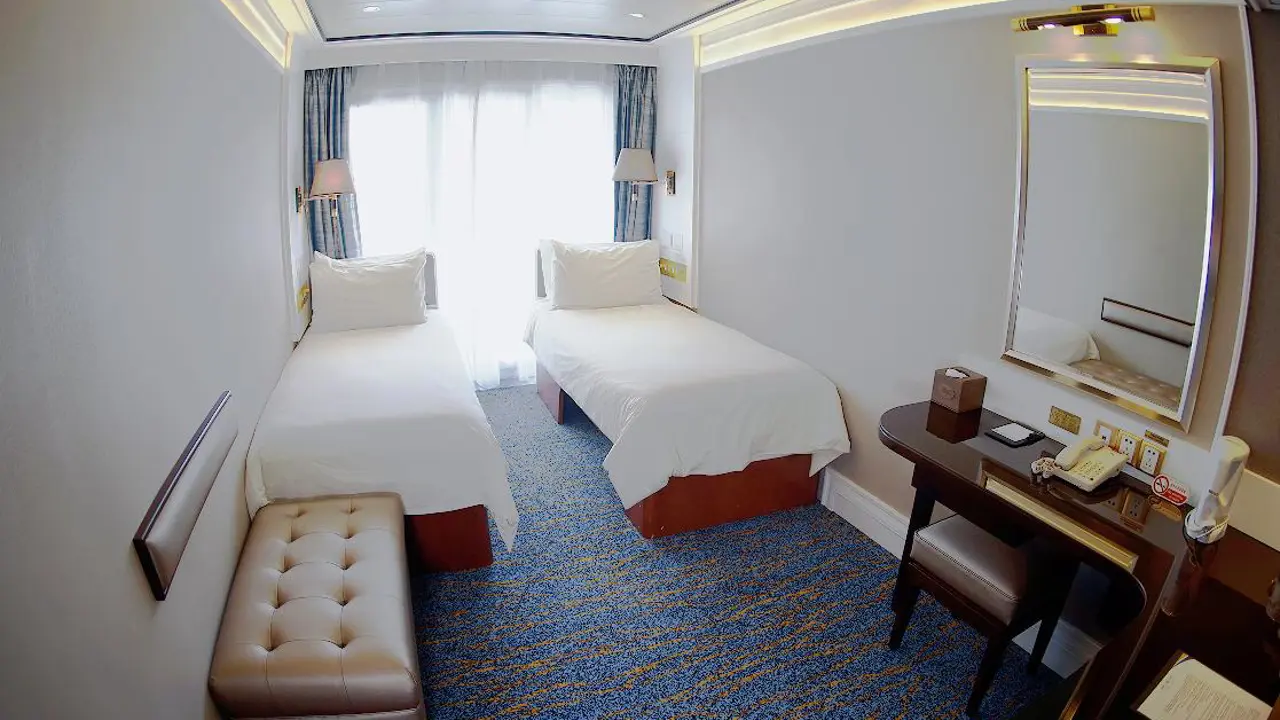 Superior twin cabin on a Victoria Cruises ship with modern furnishings, soft lighting and a large window offering river views