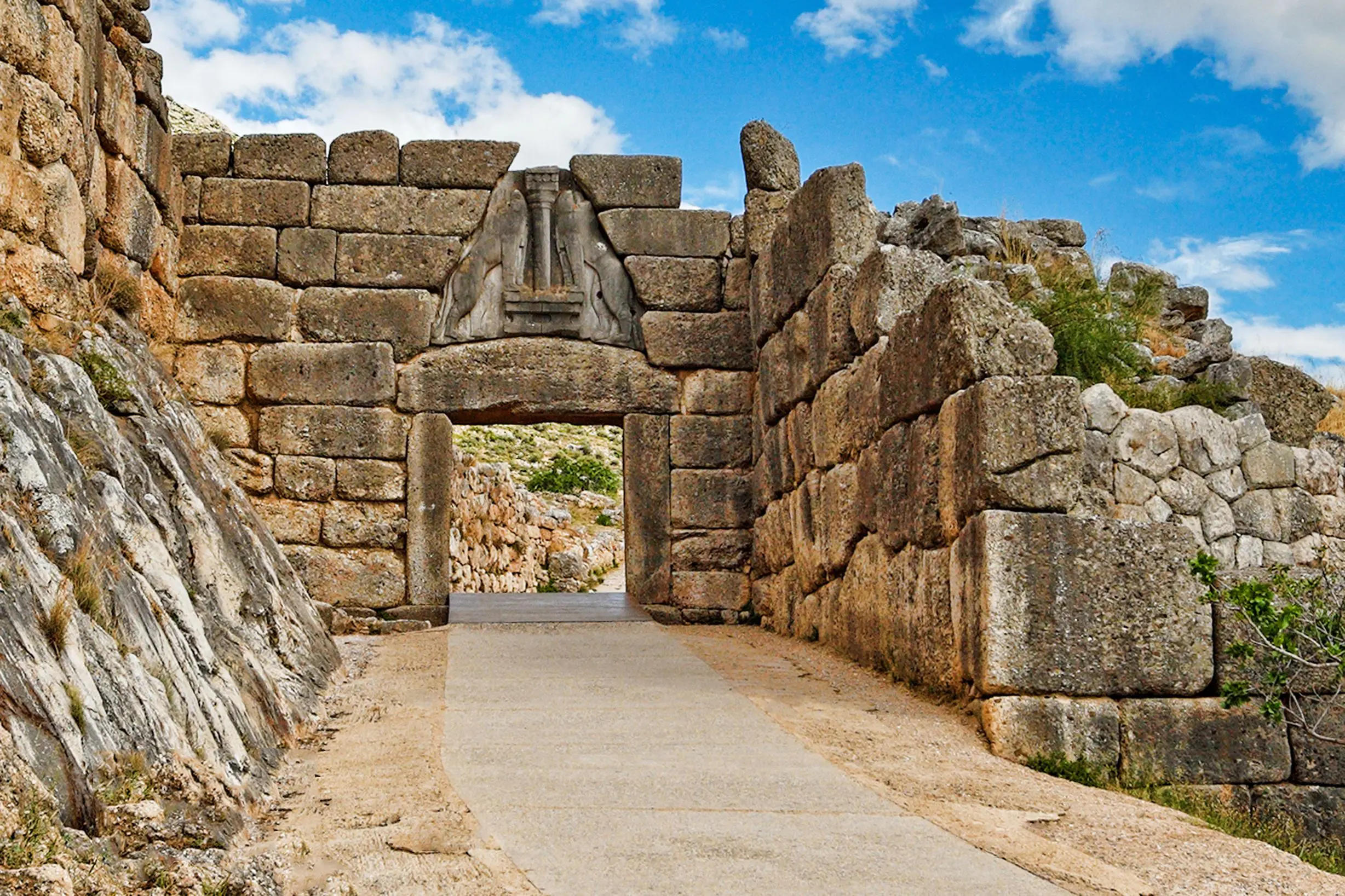 Ancient wall with an arch, with pathway going through it