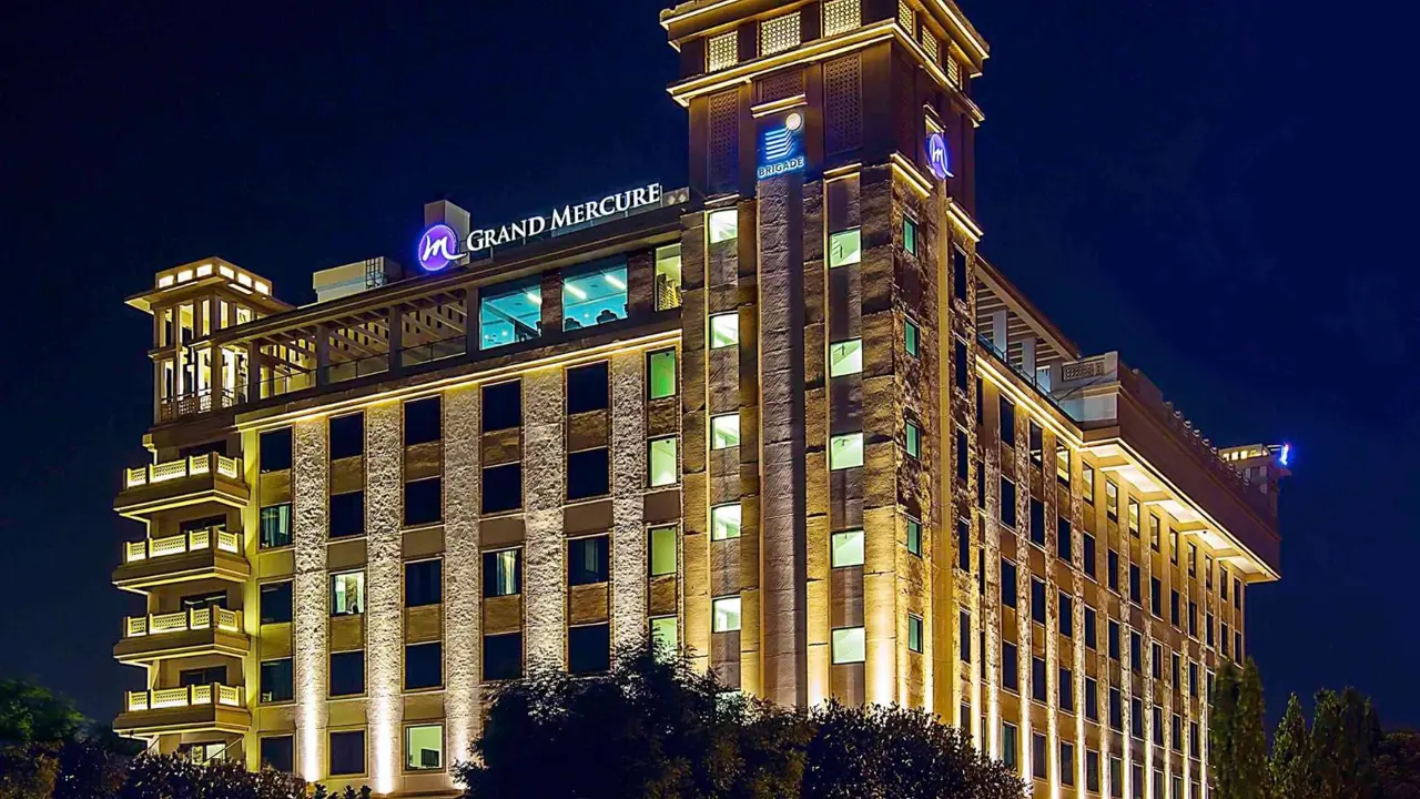 Grand exterior of the Grand Mercure Hotel in Mysore, illuminated at night