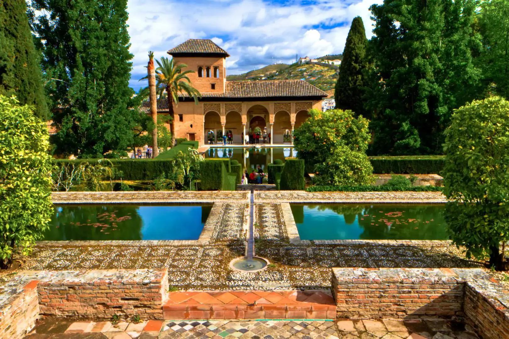 Ornate gardens and reflecting pools at the Alhambra Palace in Granada