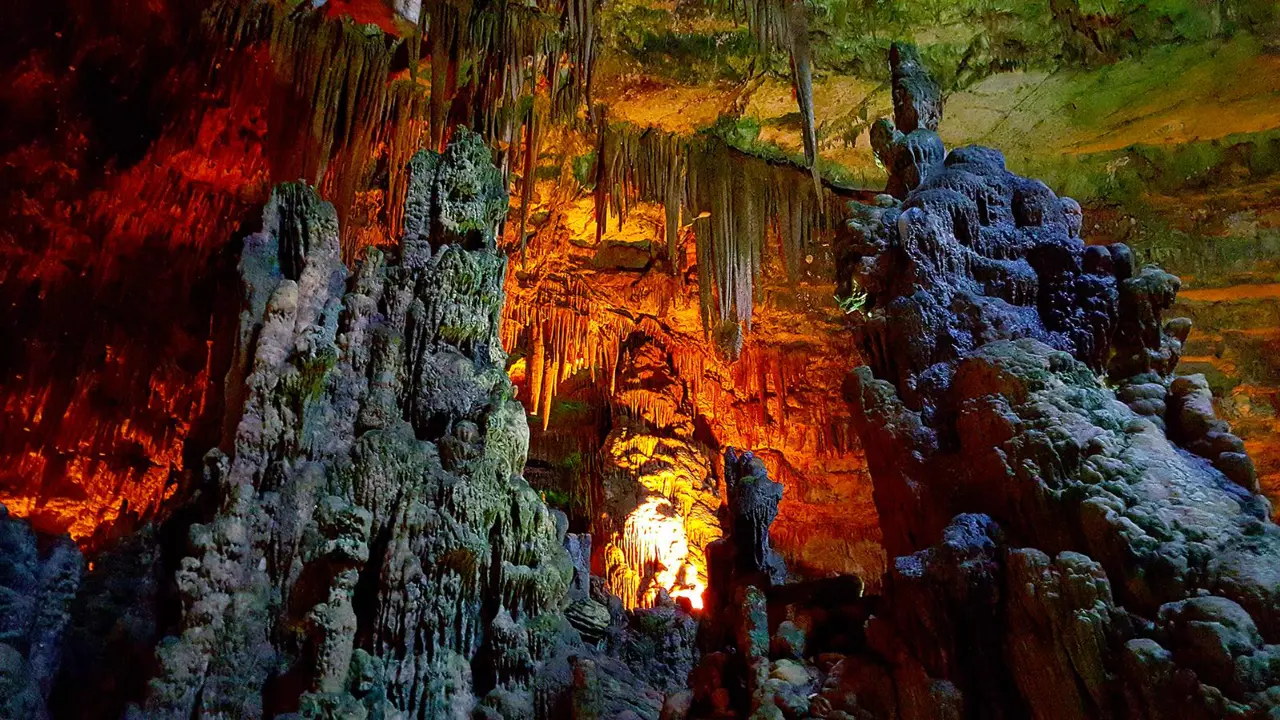 Interior view of Castellana Grotto cave with illuminated stalactites and stalagmite