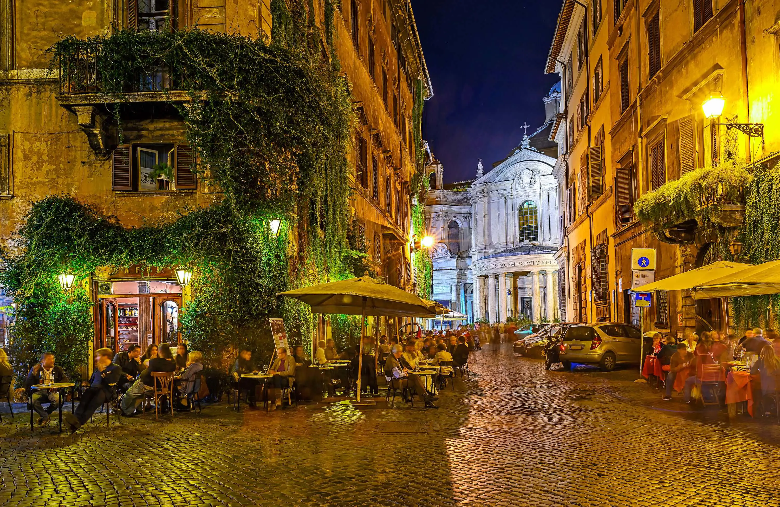 Streets of Rome at night, with people dining al fresco