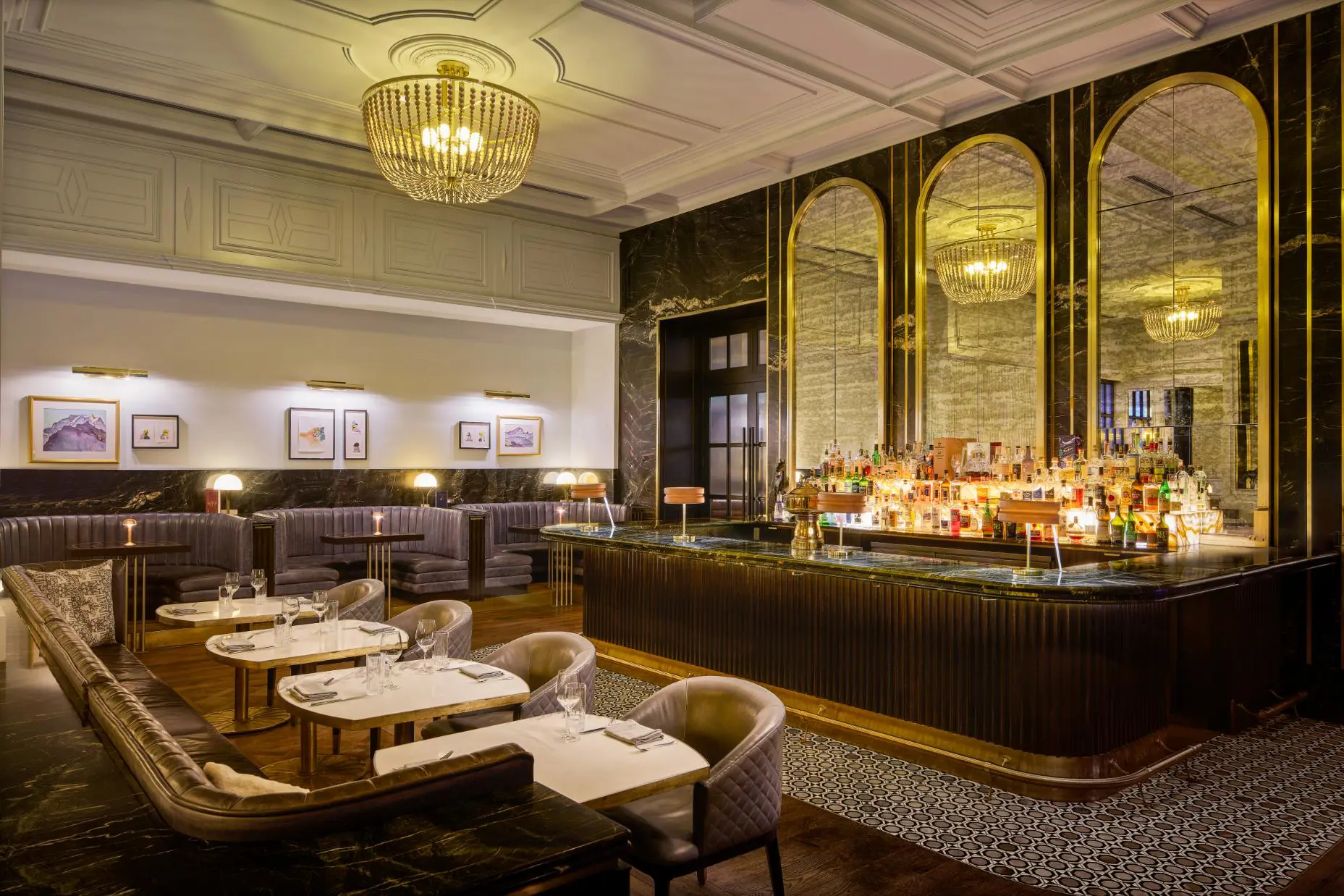 Stylish hotel bar at Fairmont Chateau with marble surfaces, golden accents, and plush seating