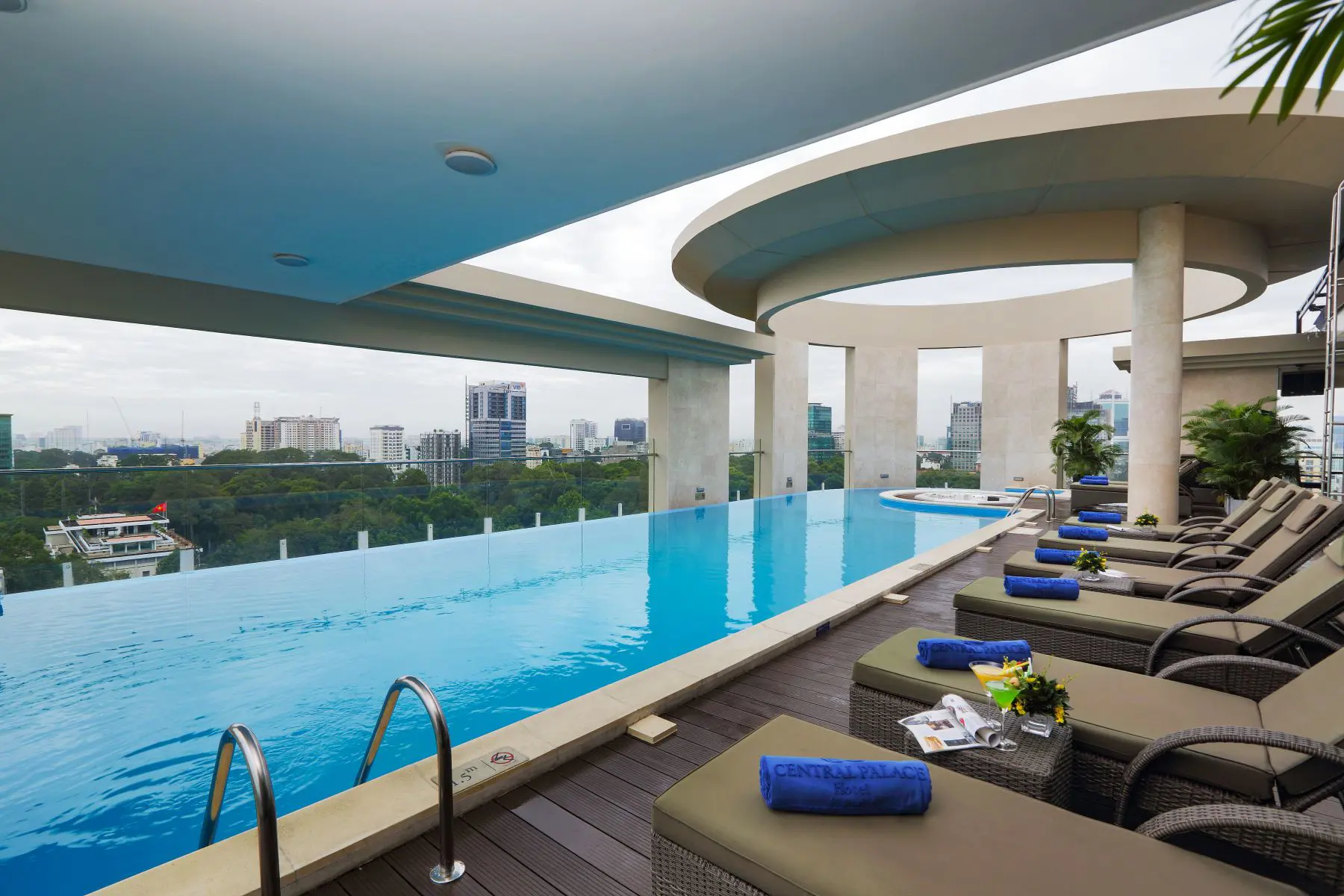Rooftop pool area at Central Palace Hotel, Ho Chi Minh City, with a sleek swimming pool, sun loungers, and panoramic views of the city skyline