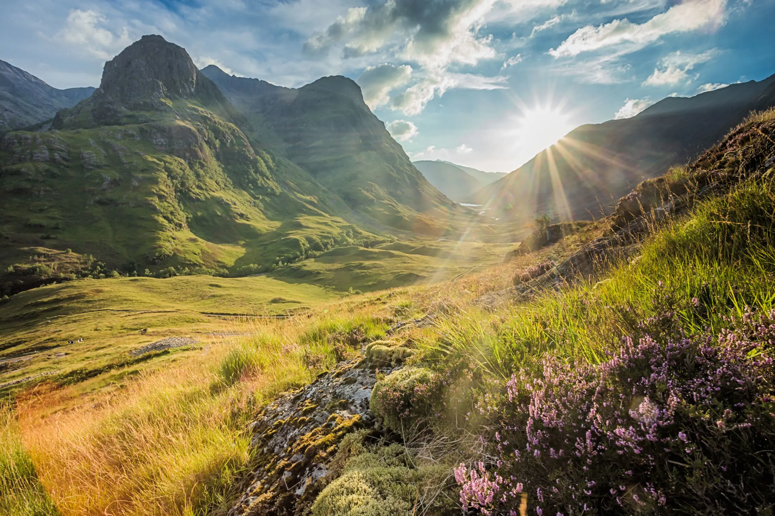 View of the Scottish Highlands with sunshine coming through behind them