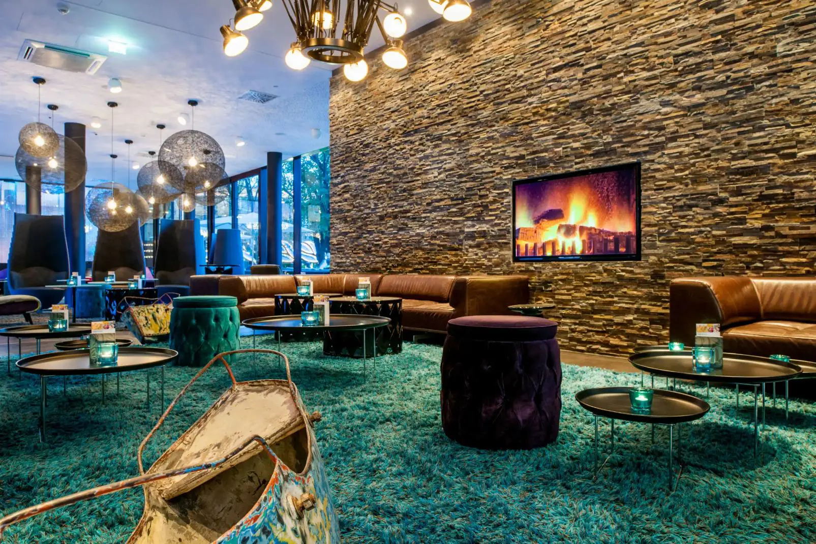 Stylish lobby lounge at Motel One Wien Prater in Vienna with modern seating and warm lighting