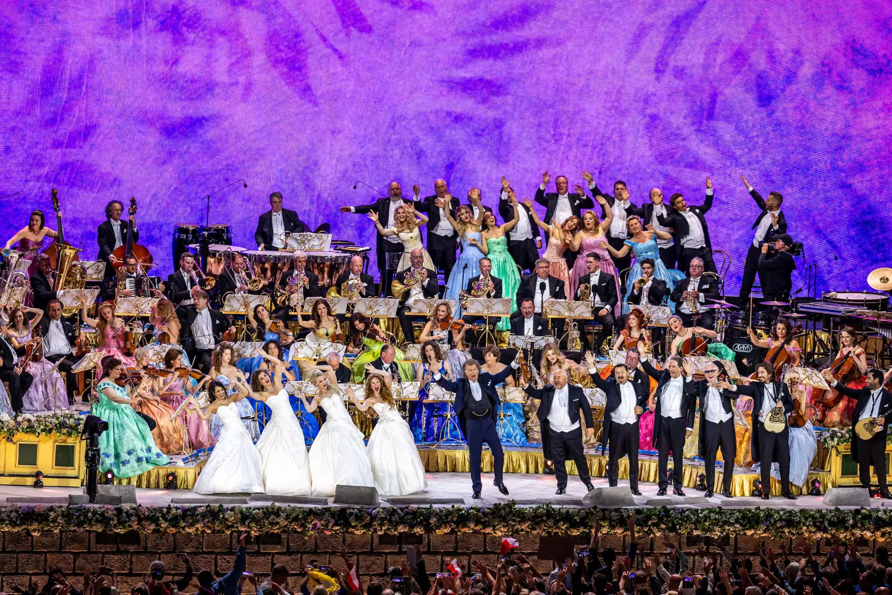 André Rieu performing in Maastricht alongside a stage of musicians and performers