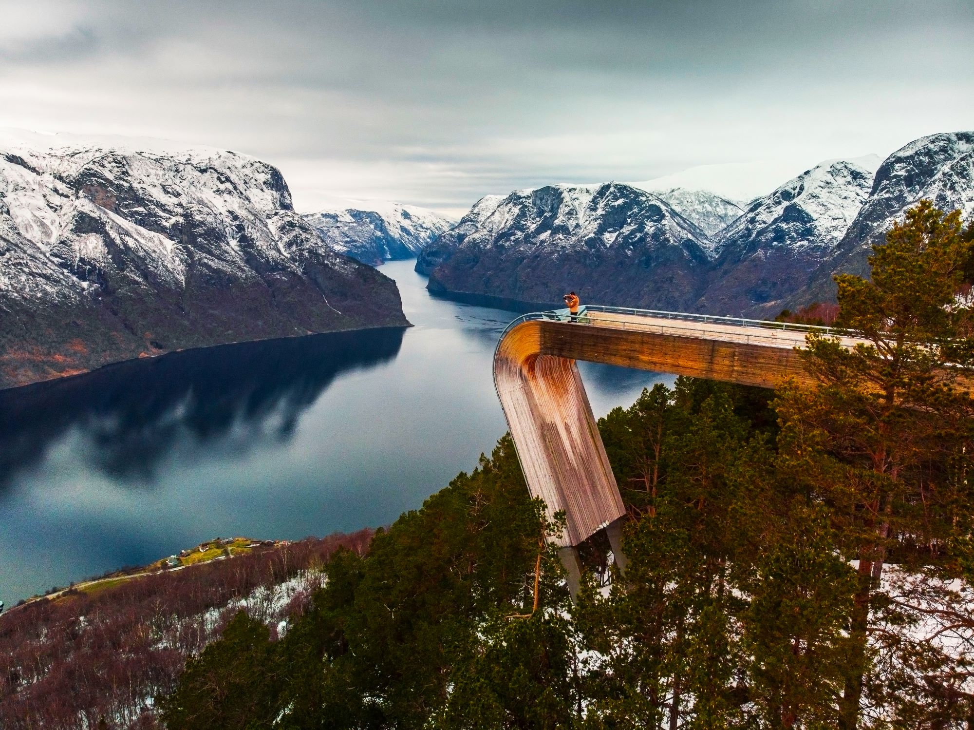 An image man standing on Stegastein Viewing Platform overlooking the fjord