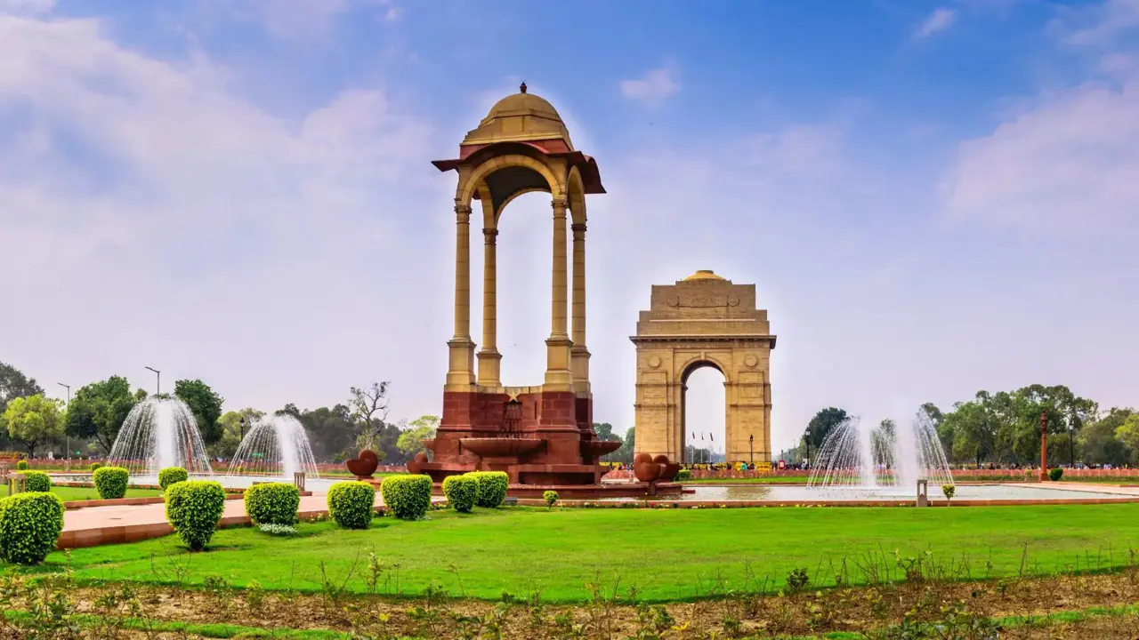 A view of India Gate and surrounding fountains and gardens in Delhi, India