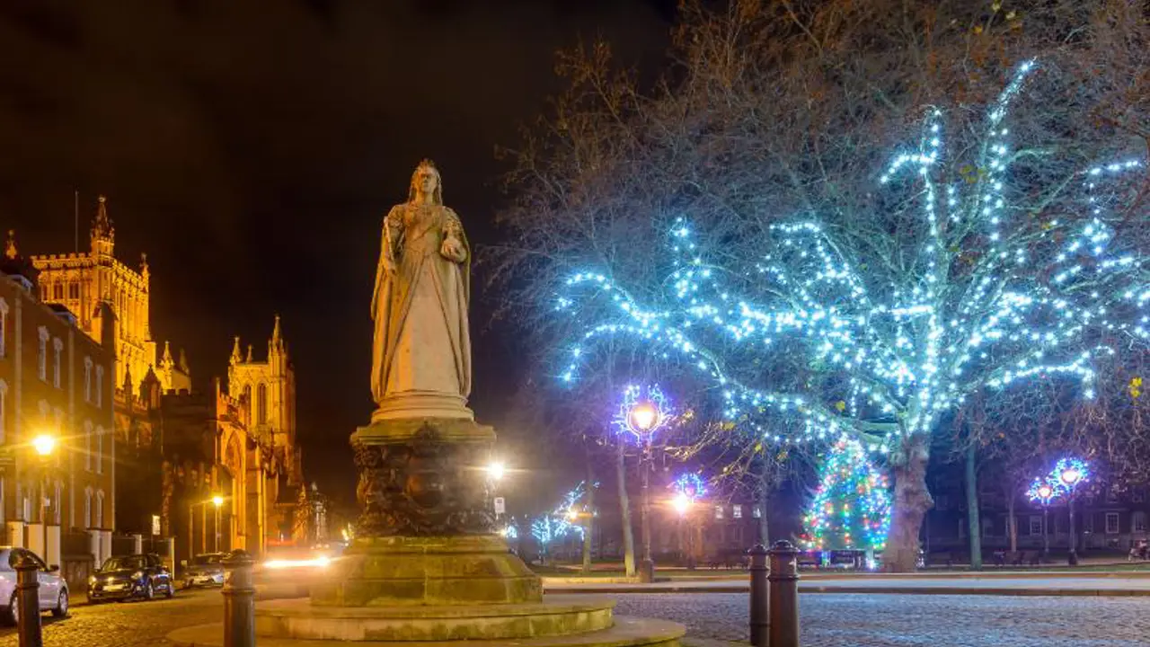 Statue of Queen Victoria with Bristol Cathedral and Christmas lights in the background