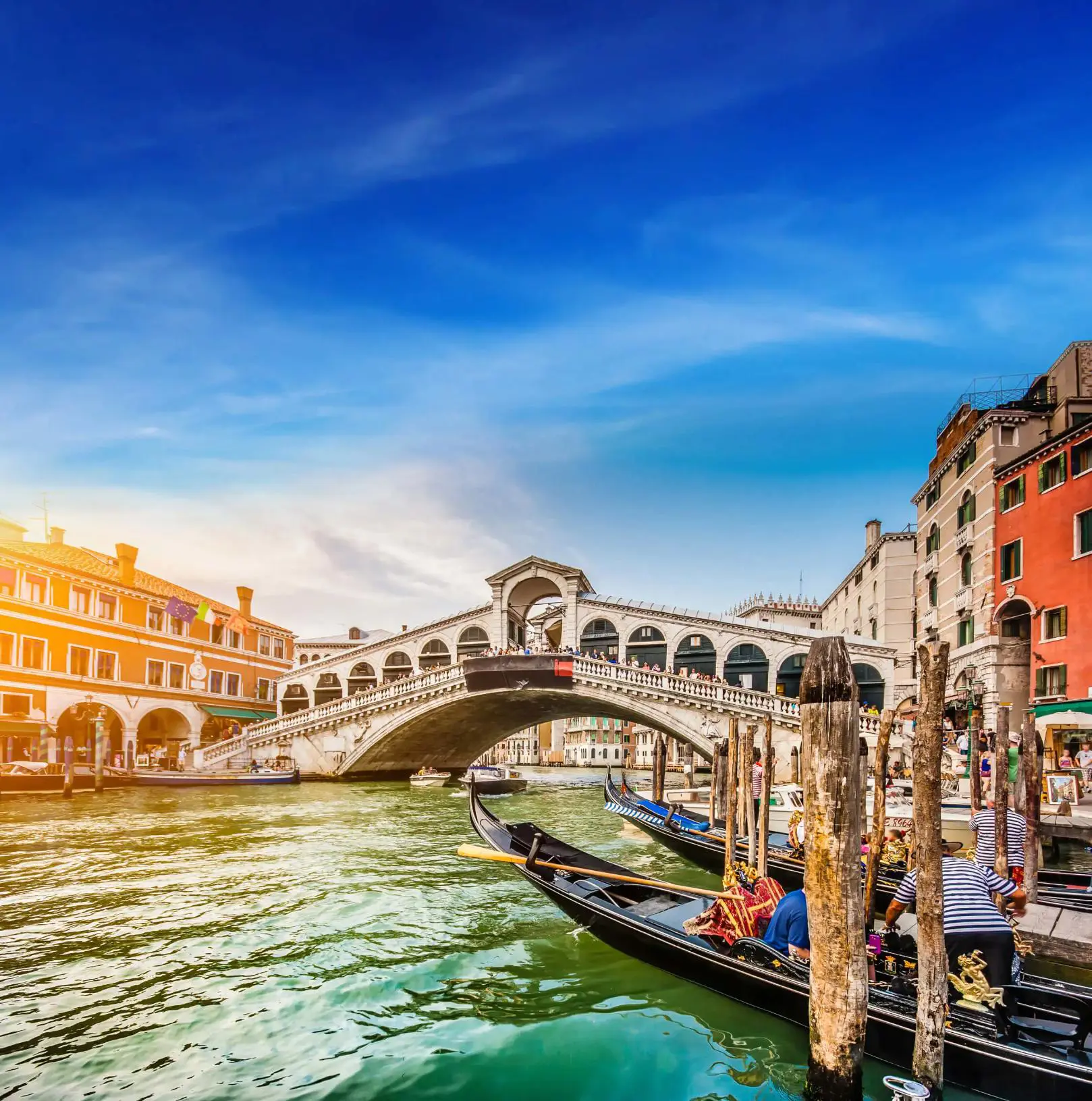 Rialto Bridge, Venice, Italy, with gondola boats in the forefront 