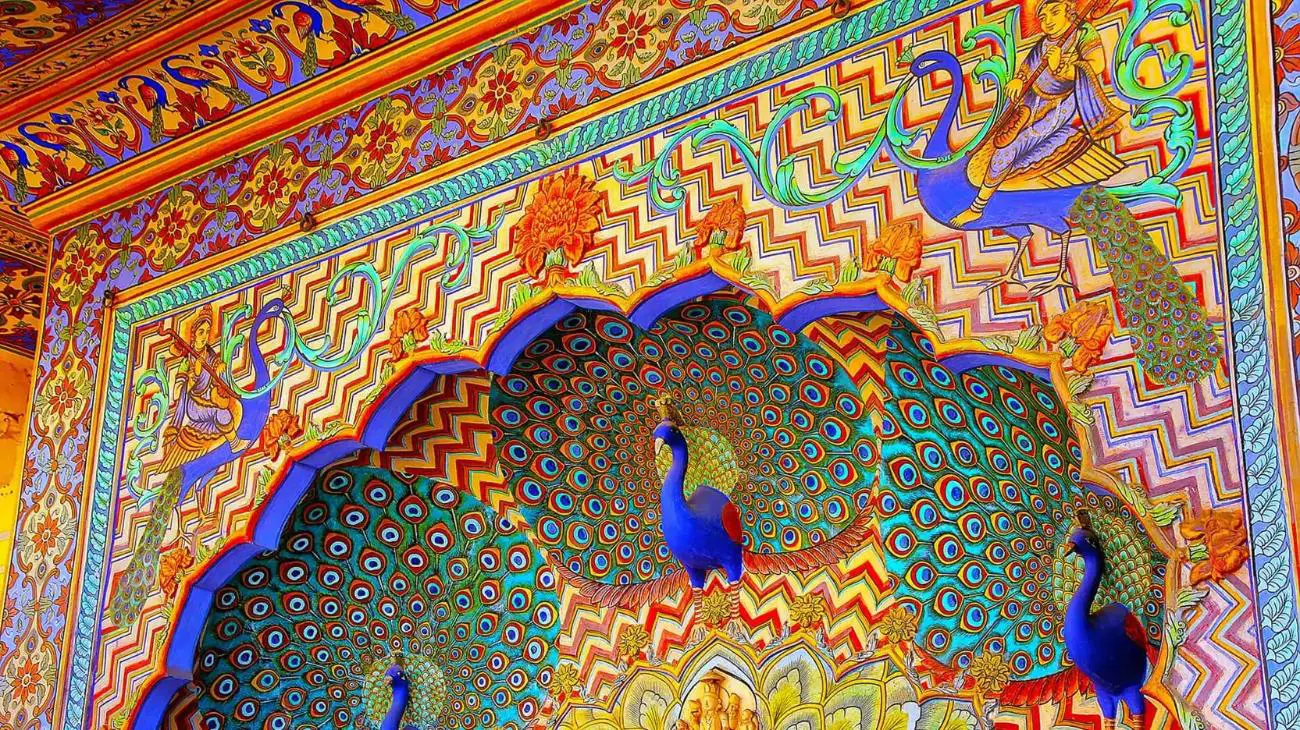 Ornate Peacock Gate at Jaipur City Palace, India, featuring intricate colourful artwork and detailed carvings inspired by peacock feathers and traditional Rajasthani design
