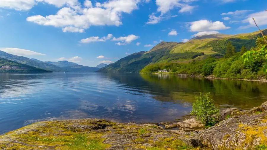 Loch surrounded by mountains in daylight