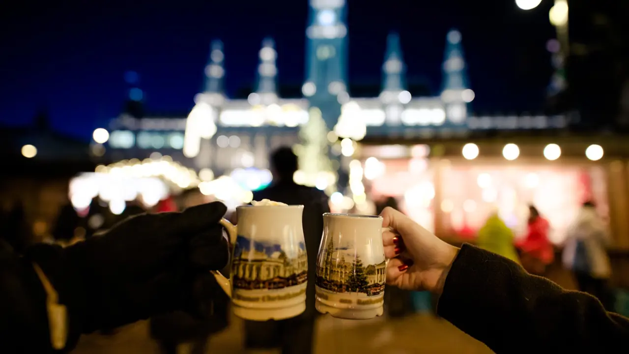 People holding traditional Punch cups in Vienna Christmas Market