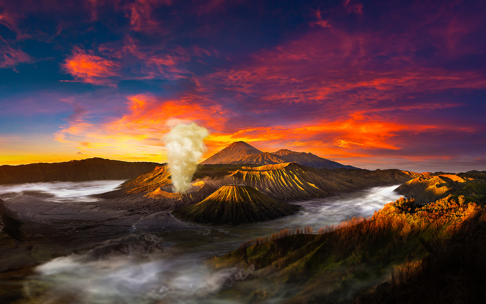 Mount Bromo volcano rising above the Sea of Sand in Bromo Tengger Semeru National Park at sunrise, East Java