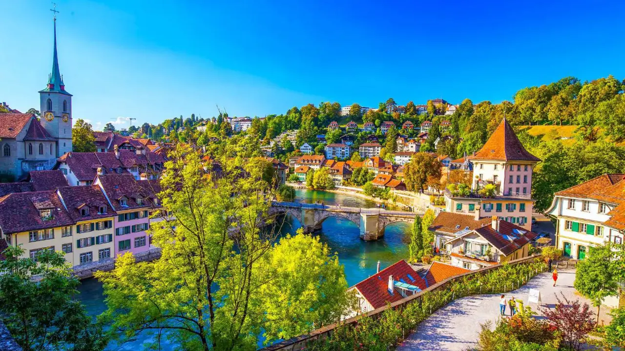 Panoramic view Bern, Switzerland, featuring the historic old town with its medieval buildings and the Aare River flowing through the city