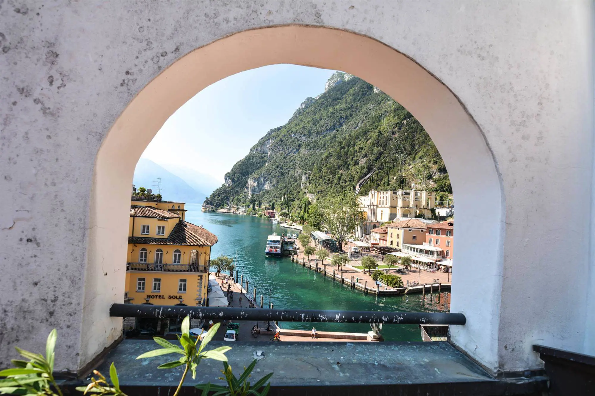 View of Lake Garda through arch-shaped hole in a wall