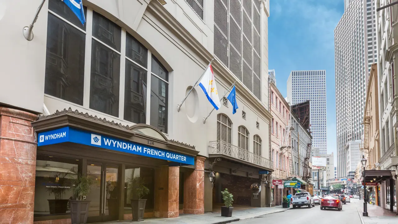 Exterior of Wyndham French Quarter in New Orleans, featuring large windows overlooking the street