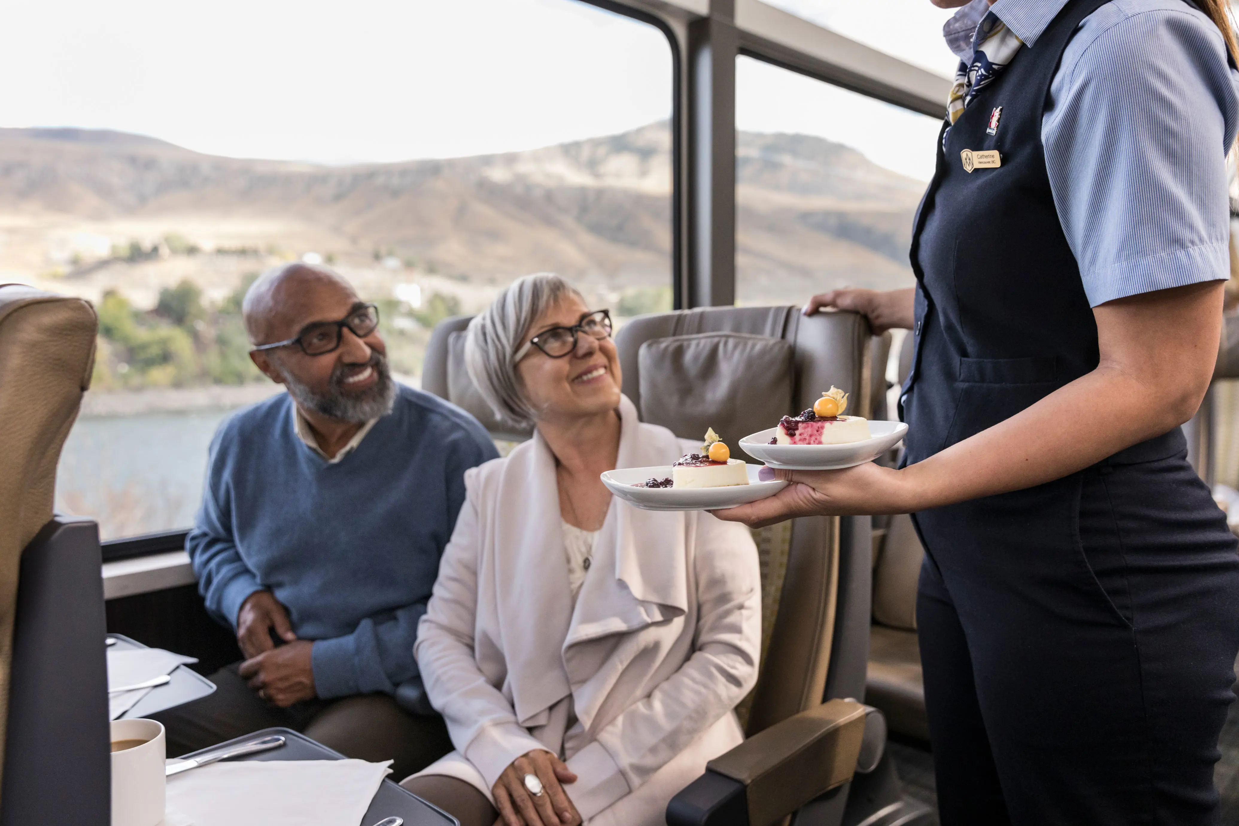 Couple Being Served On Train Through Canadian Rockies