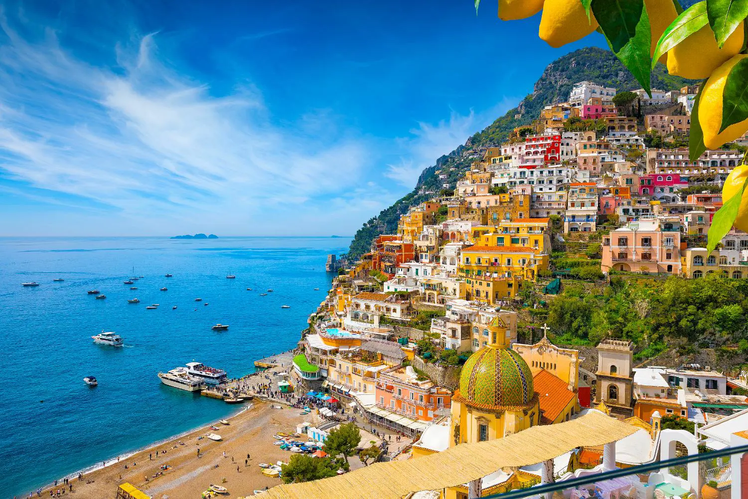 Colourful cliffside village of Positano on the Amalfi Coast, Italy, with pastel-coloured houses cascading down steep hills towards the sparkling blue Mediterranean Sea