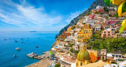 Colourful cliffside village of Positano on the Amalfi Coast, Italy, with pastel-coloured houses cascading down steep hills towards the sparkling blue Mediterranean Sea