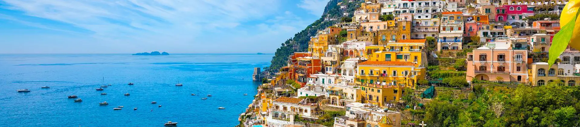 Colourful cliffside village of Positano on the Amalfi Coast, Italy, with pastel-coloured houses cascading down steep hills towards the sparkling blue Mediterranean Sea