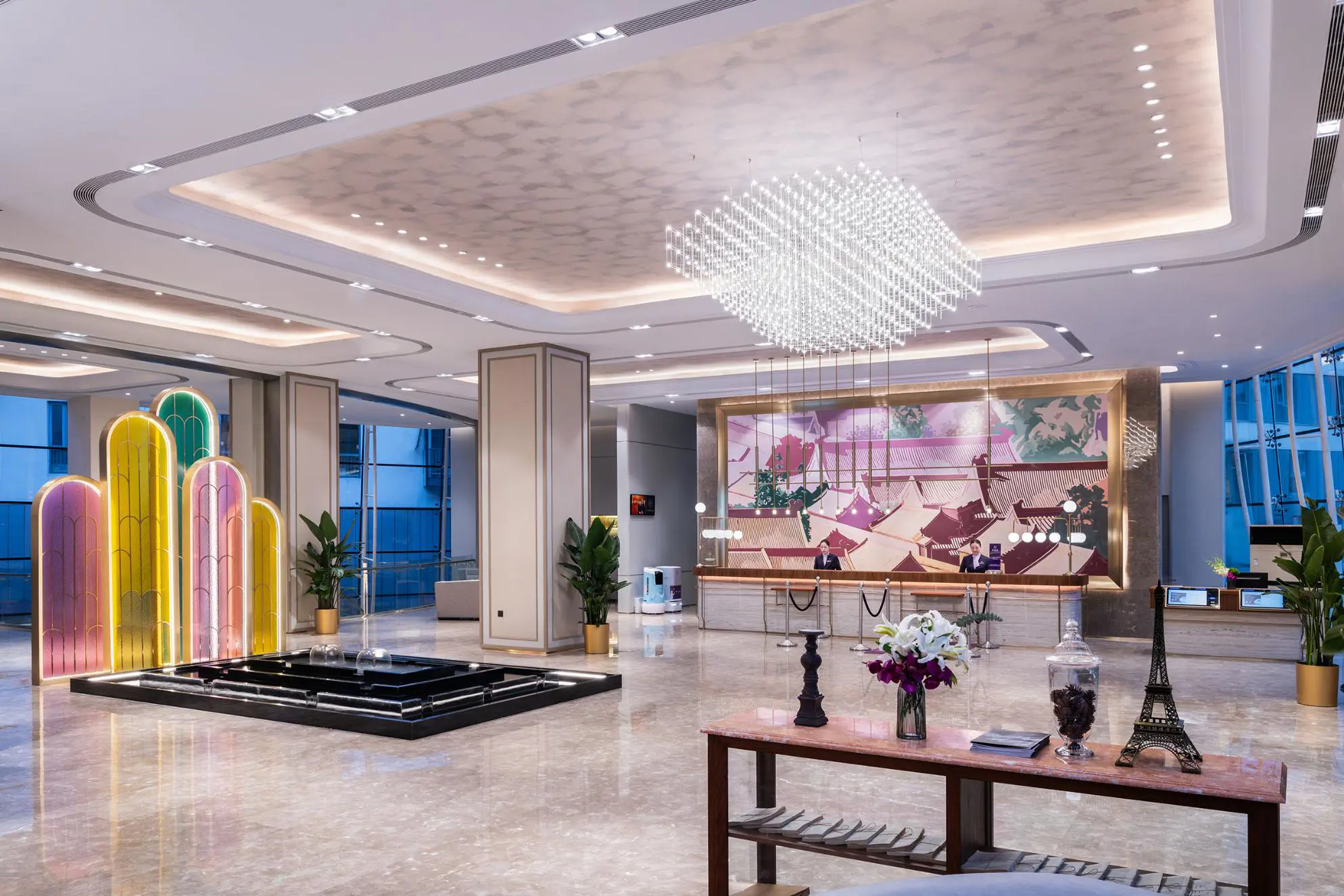 Elegant lobby with marble flooring, bronze accents and geometric ceiling lighting at the Mercure Beijing Downtown Hotel in Beijing, China