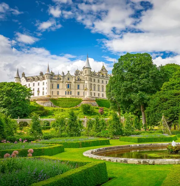 A view of historic Dunrobin Castle in Scotland, with its tall spires and turrets