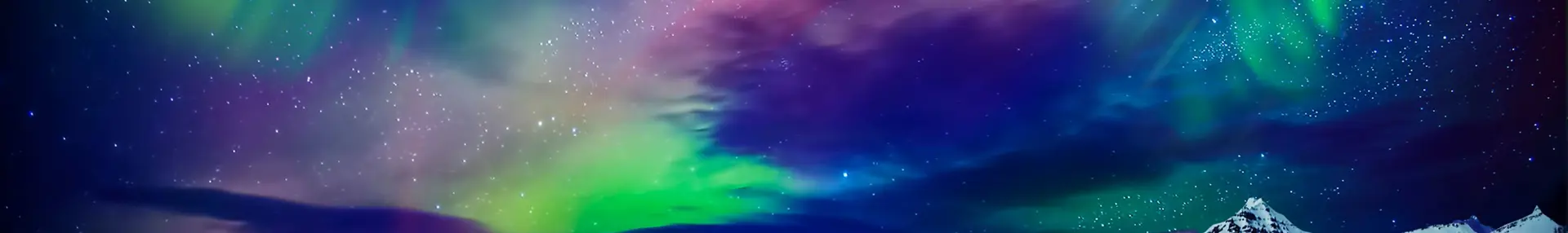 Starry sky with green, purple and blue Northern Lights. Below, a lake and a snowy mountain