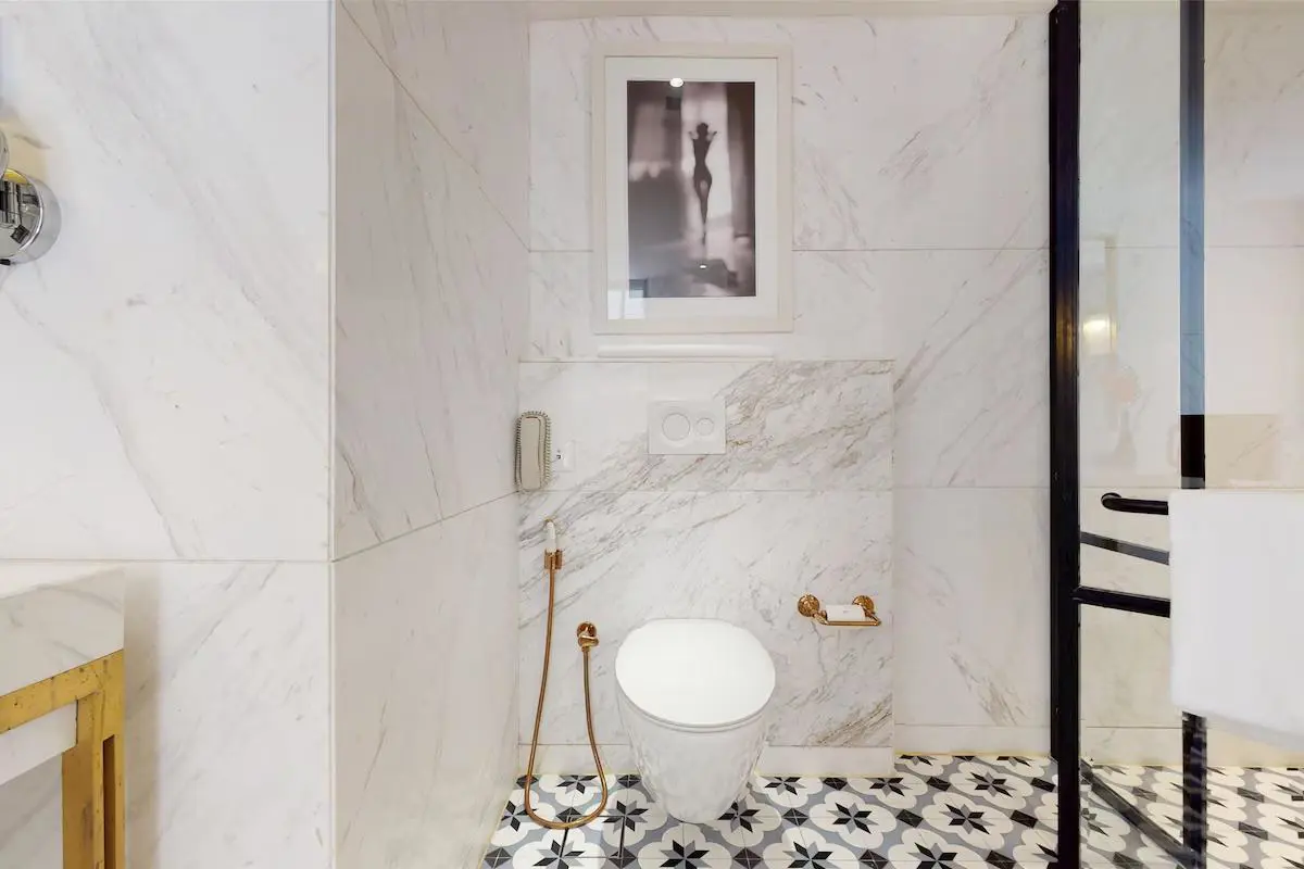 A stylish bathroom at the Radisson Hotel Jass in Shimla, with marble walls, modern fittings and patterned floor tiles