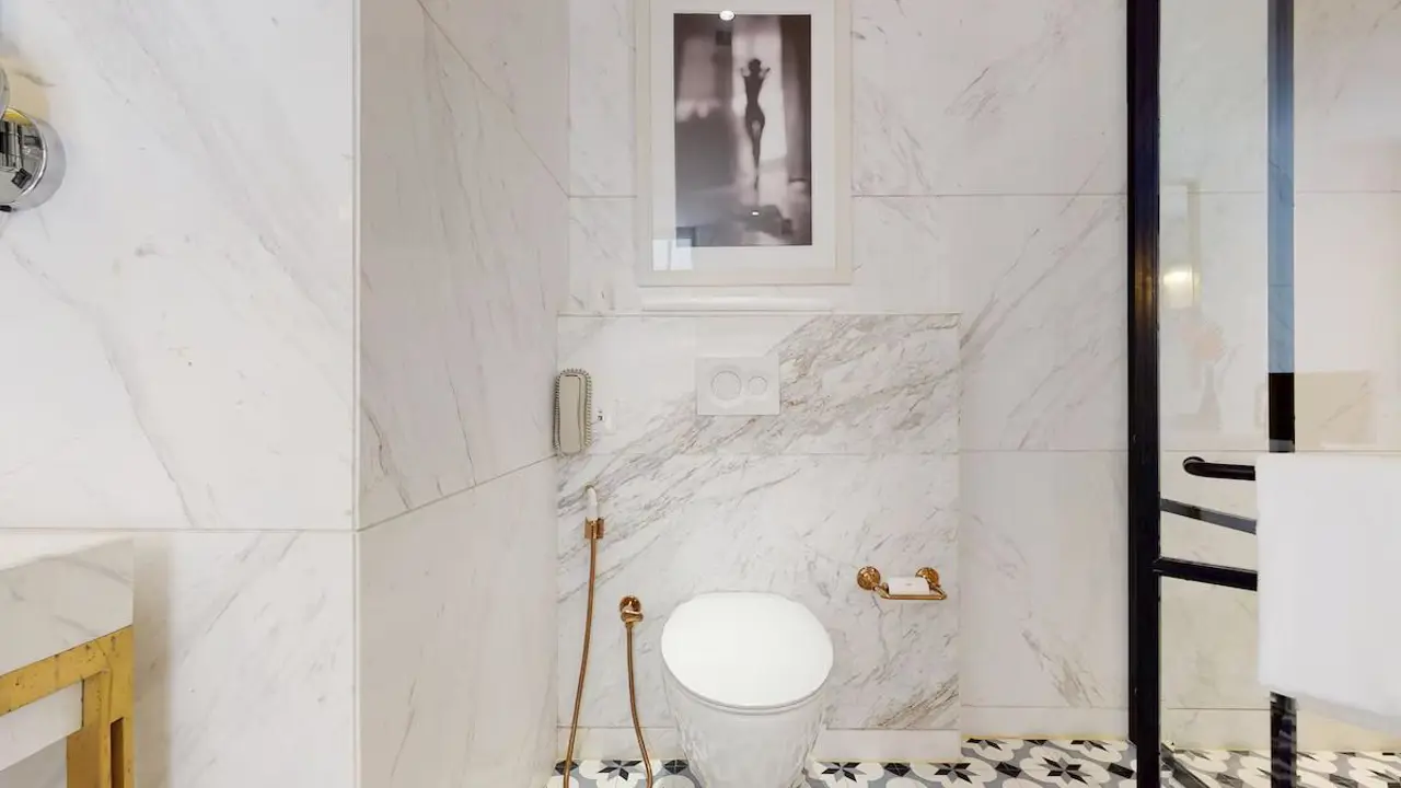 A stylish bathroom at the Radisson Hotel Jass in Shimla, with marble walls, modern fittings and patterned floor tiles