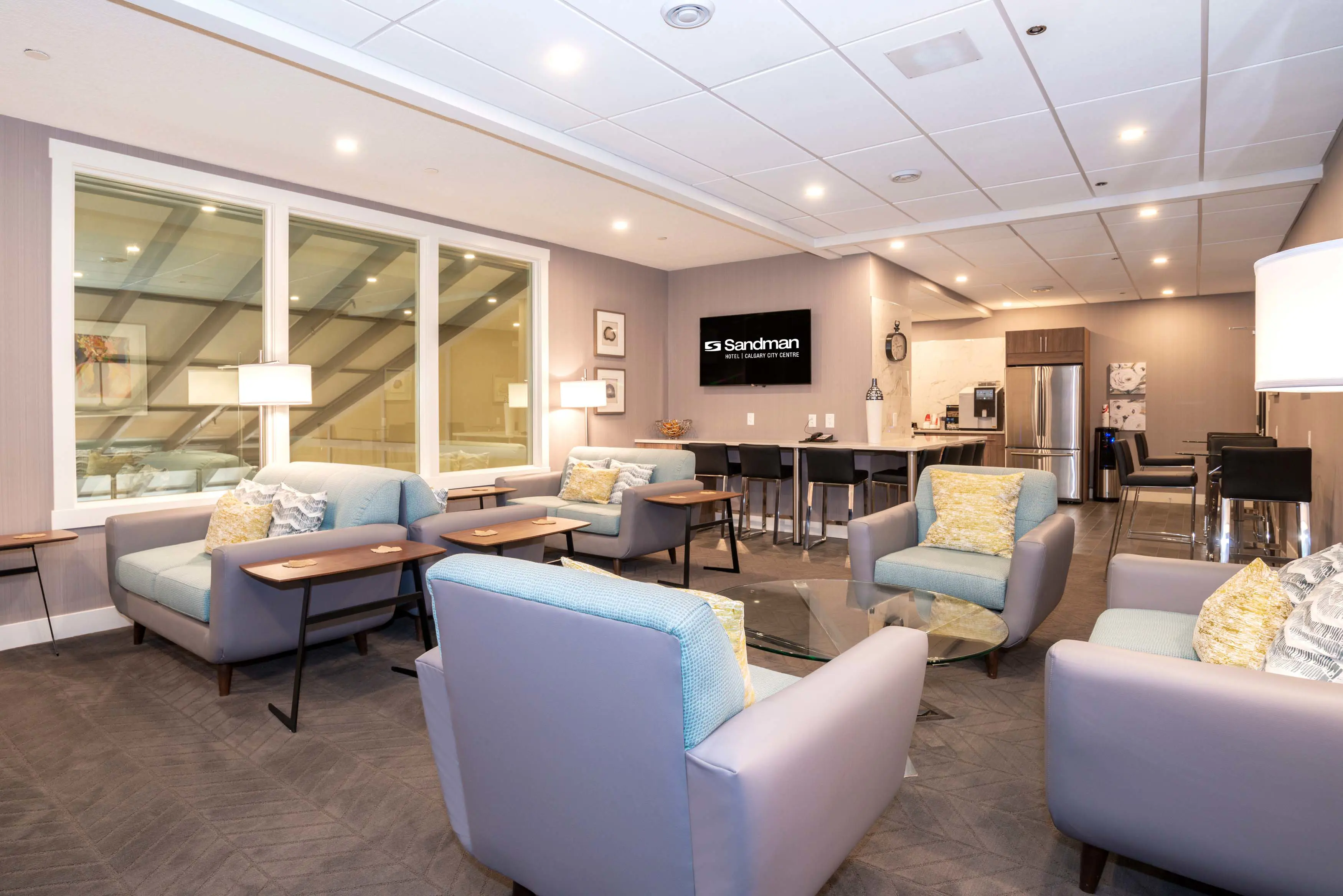 Bright and airy lounge at Sandman Signature Calgary Downtown, Calgary, featuring contemporary design and comfortable seating