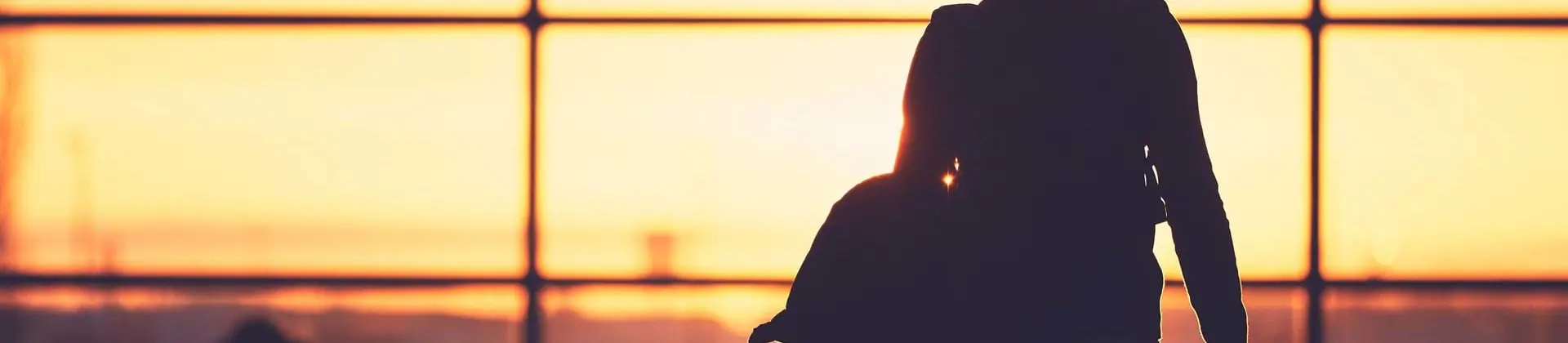 Person walking to departure gate in an airport
