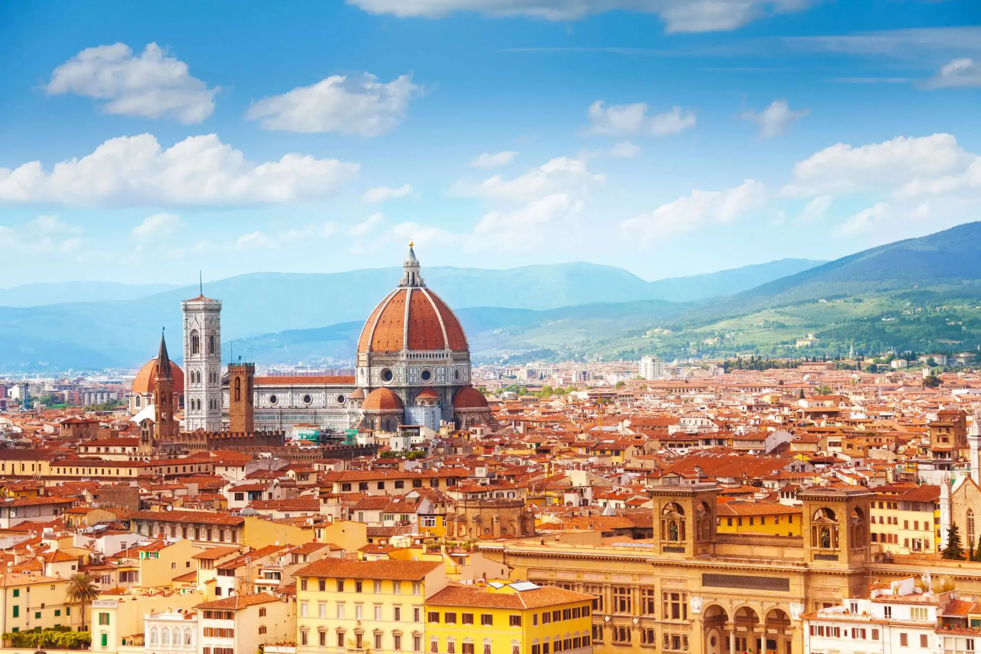 Panoramic view of Florence, Italy, with the Cathedral of Santa Maria del Fiore rising amongst the terracotta rooftops